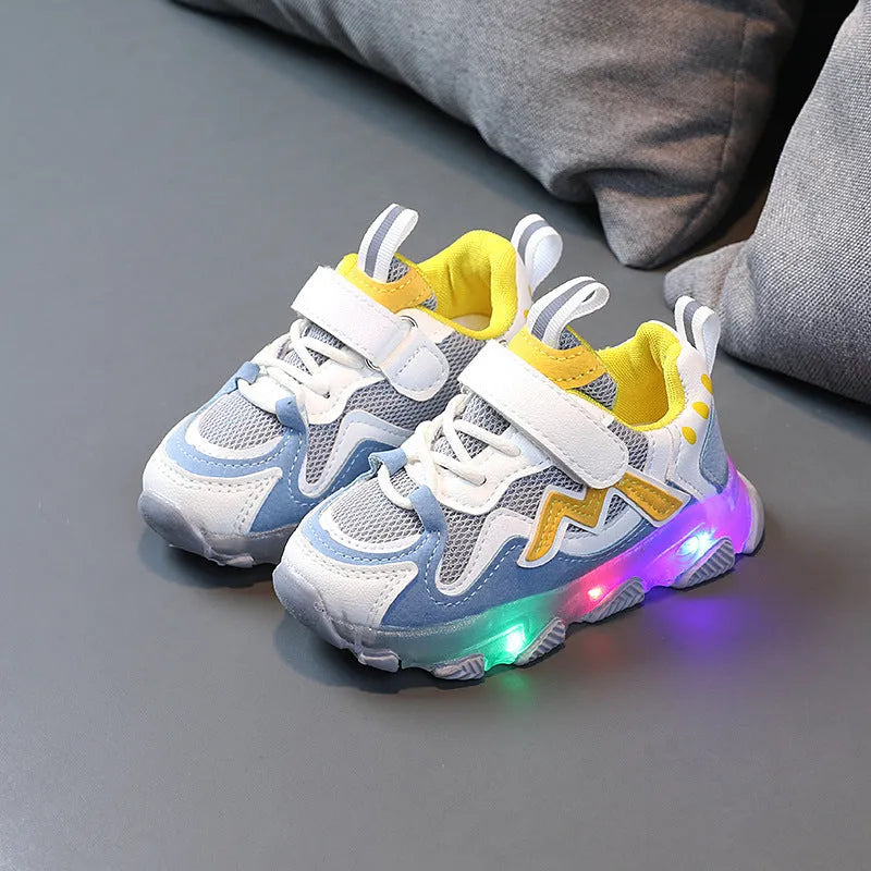 Children's grey sneakers with breathable mesh panels and a white Velcro strap on a wear-resistant rubber sole.