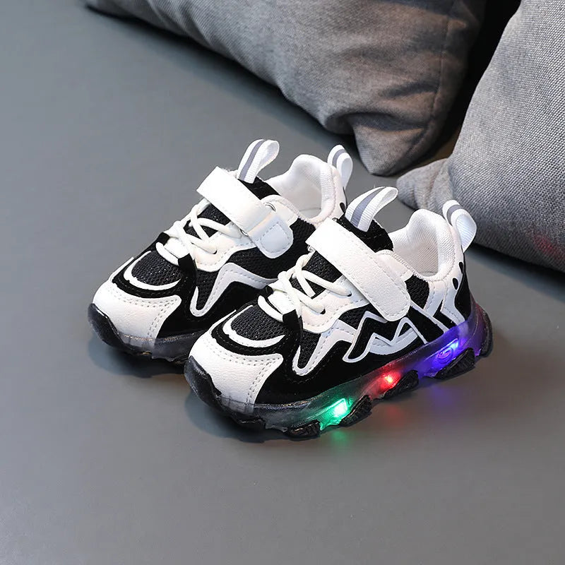 Children's grey sneakers with breathable mesh panels and a white Velcro strap on a wear-resistant rubber sole.