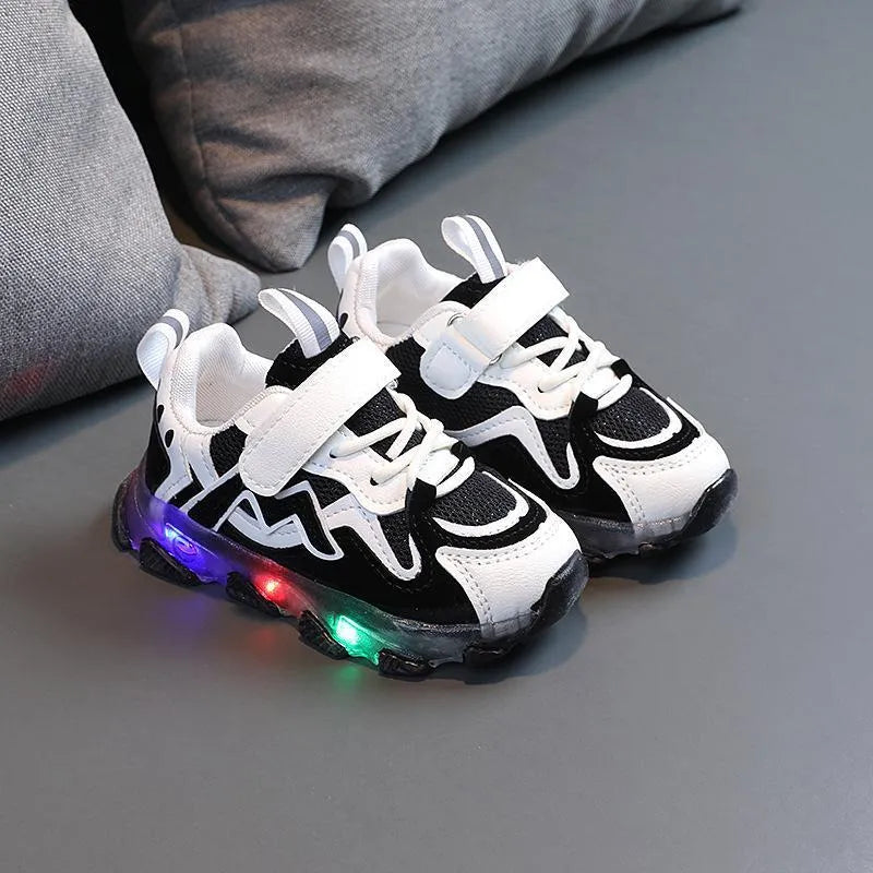 Children's grey sneakers with breathable mesh panels and a white Velcro strap on a wear-resistant rubber sole.
