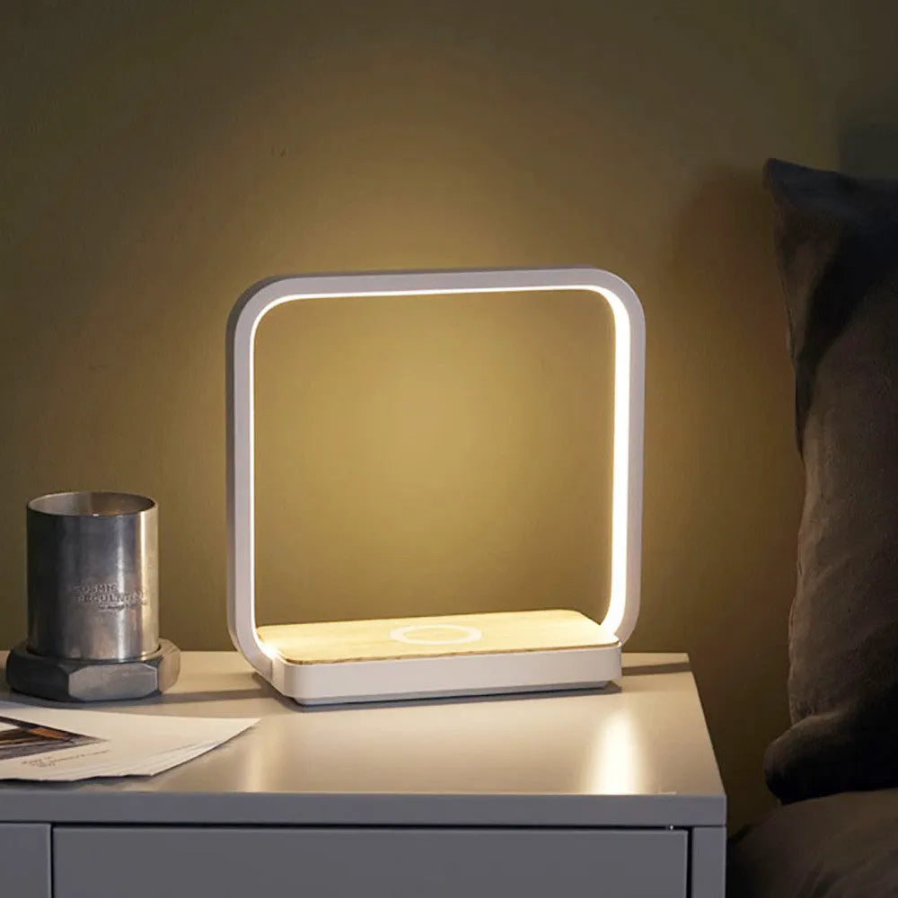 Modern smart bedside lamp with touch base and aluminium shade in white or gold, showing USB cable.