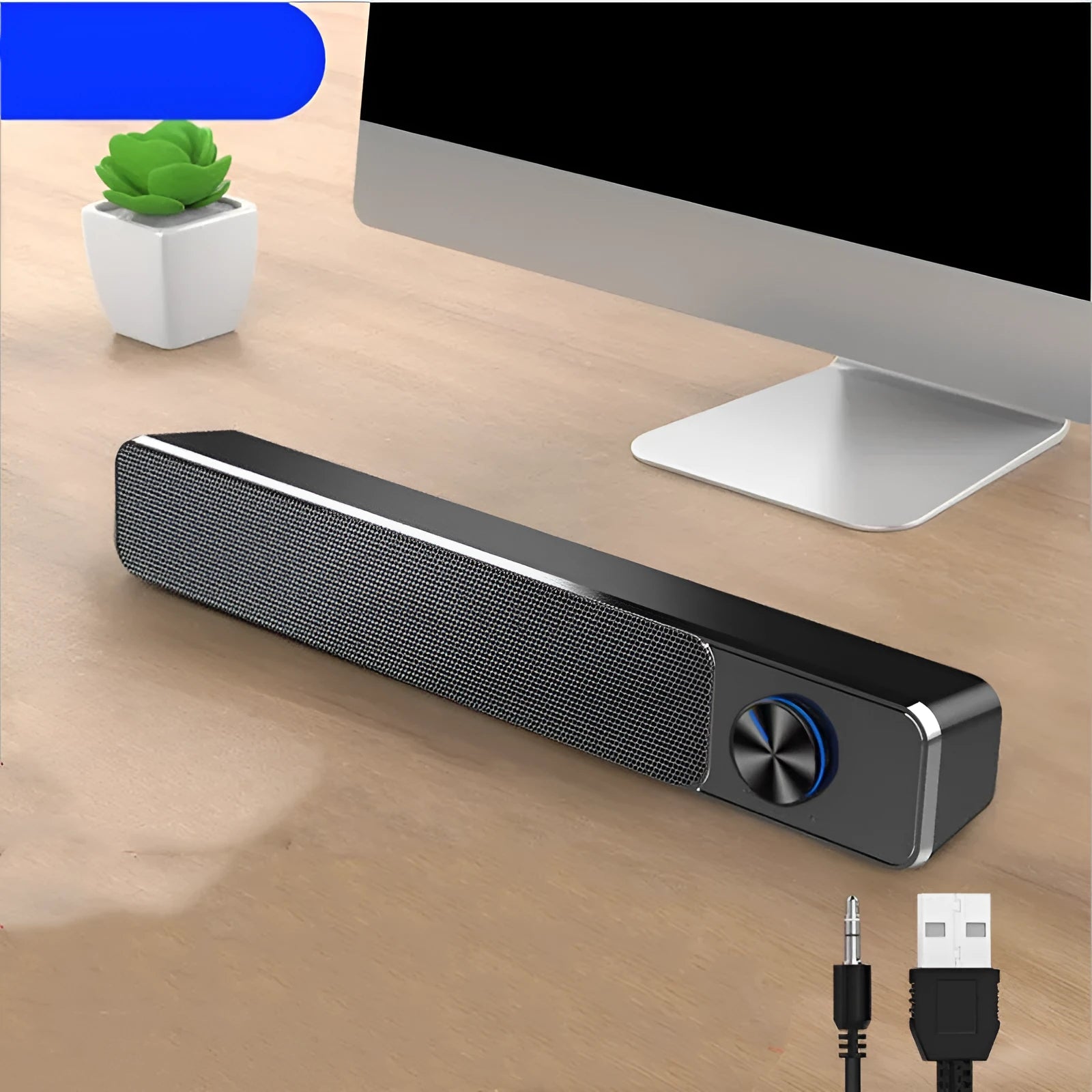 Black and white USB-powered desktop computer speakers with 2.0 stereo sound on a wooden desk.