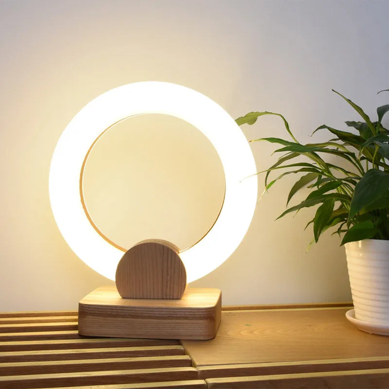 Nordic style wooden circular chandelier with acrylic shade in a living room setting.