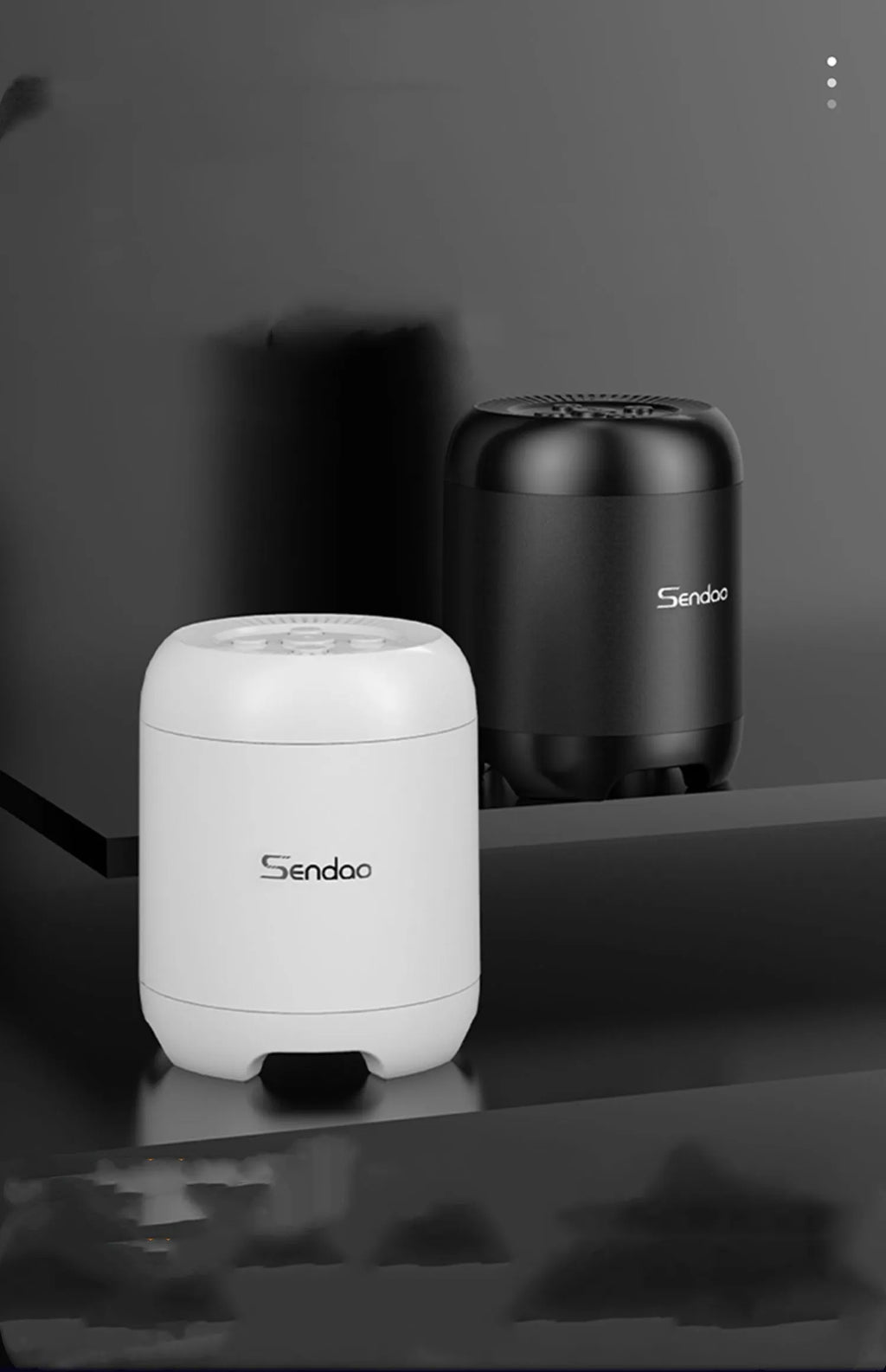 Compact black or white wireless Bluetooth speaker with USB port and card slot.