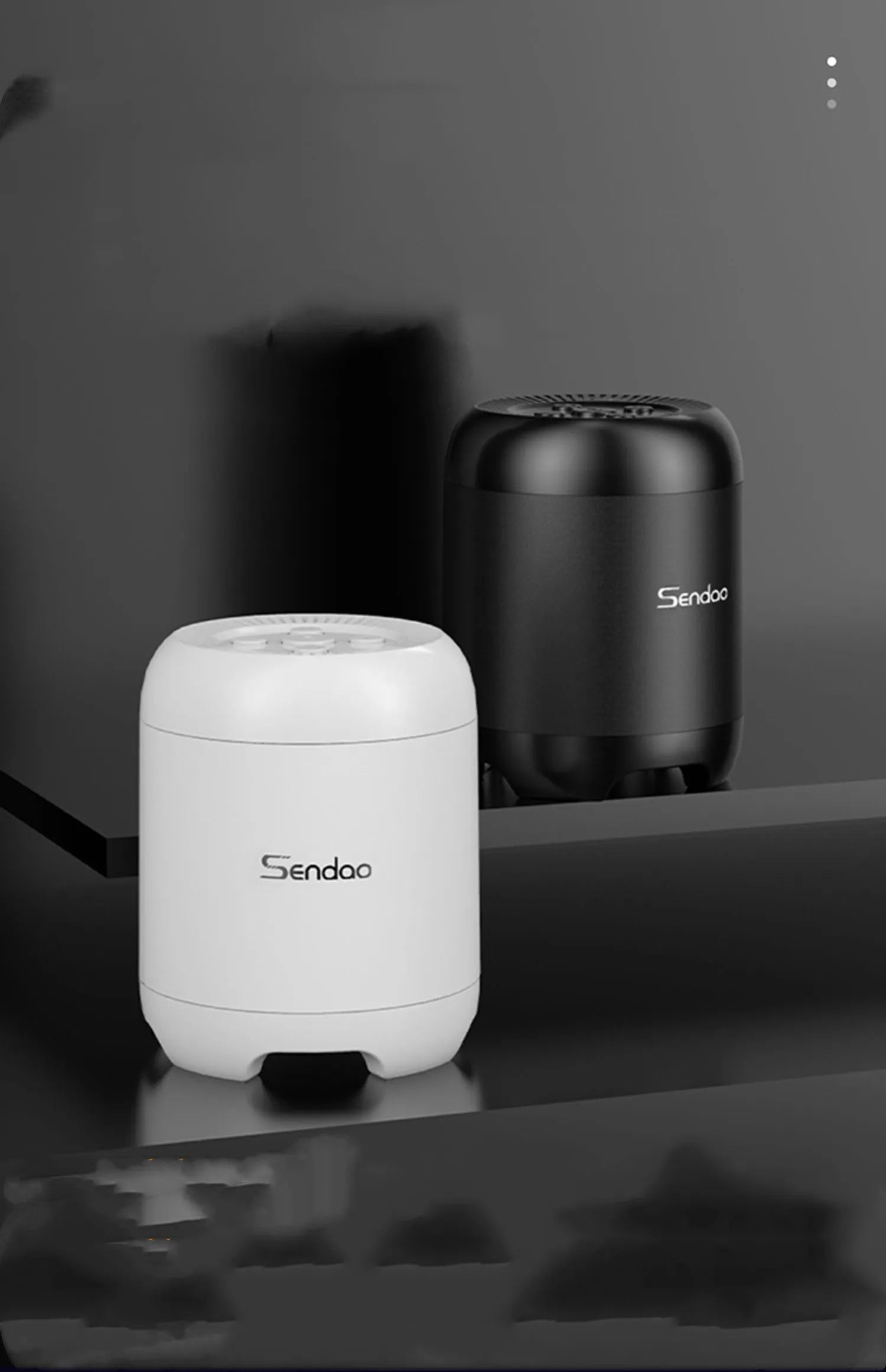 Compact black or white wireless Bluetooth speaker with USB port and card slot.