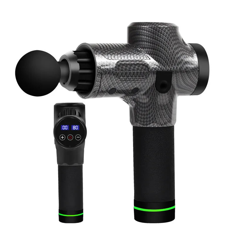 Black electric muscle massage gun with multiple interchangeable heads on a table.
