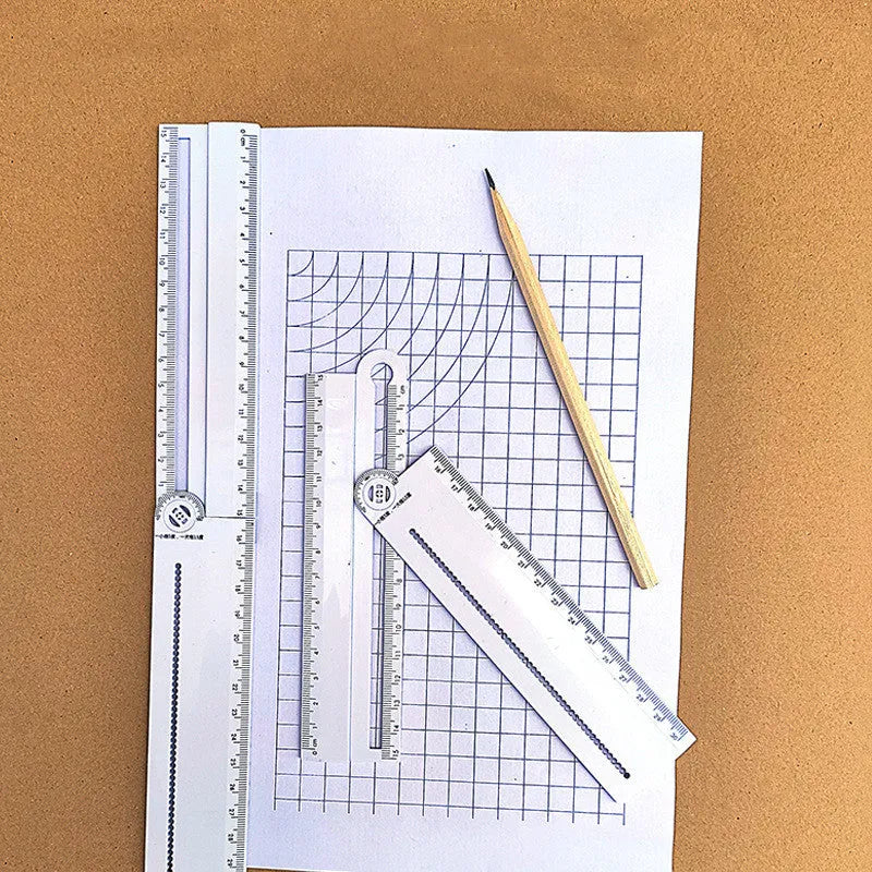 White plastic multi-function ruler measuring 30cm in length on a drawing surface.