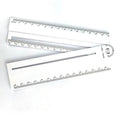 White plastic multi-function ruler measuring 30cm in length on a drawing surface.