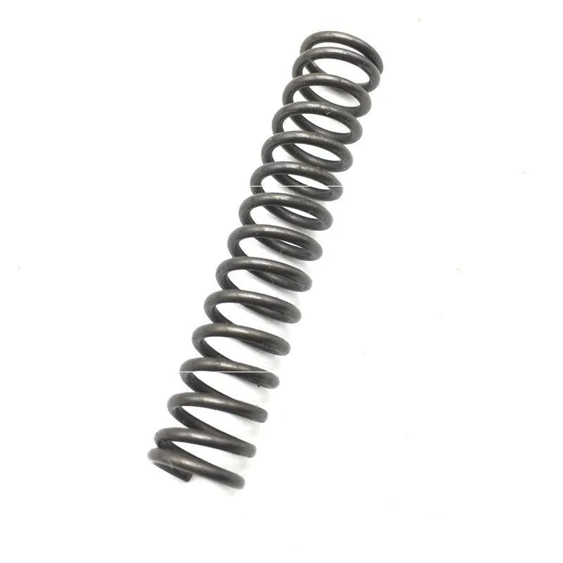 Set of metal pneumatic belt machine accessories including rollers, blades, a switch, and couplings on a workbench.