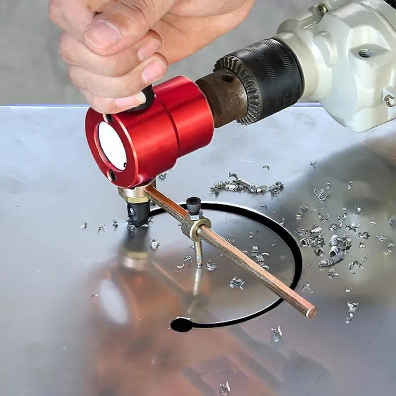 Red metal nibbler drill attachment for cutting sheet metal, shown with adjustable cutter heads.