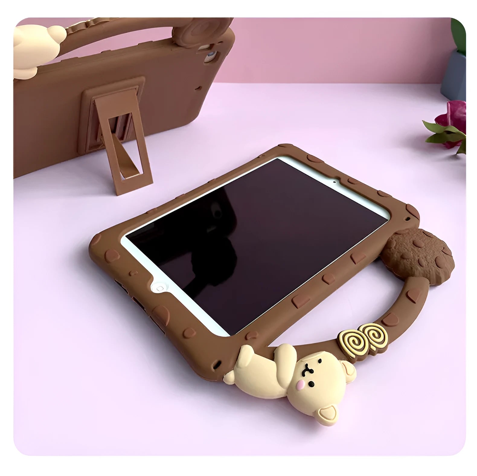 Brown cartoon-design silicone sleeve with integrated stand, fitted on an iPad tablet.
