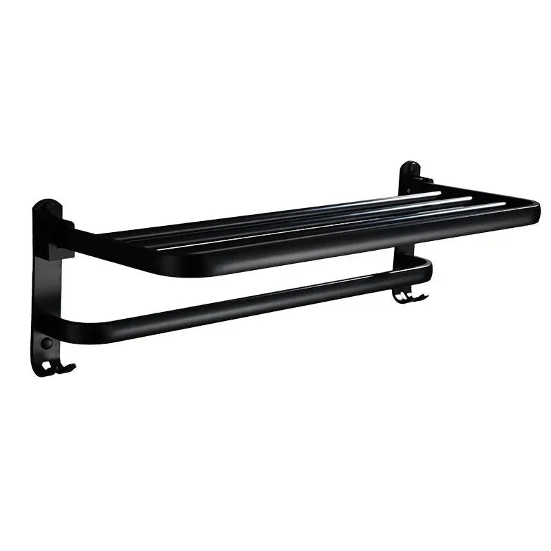Silver aluminium two-tier folding towel rack with perforated shelves mounted on a bathroom wall.