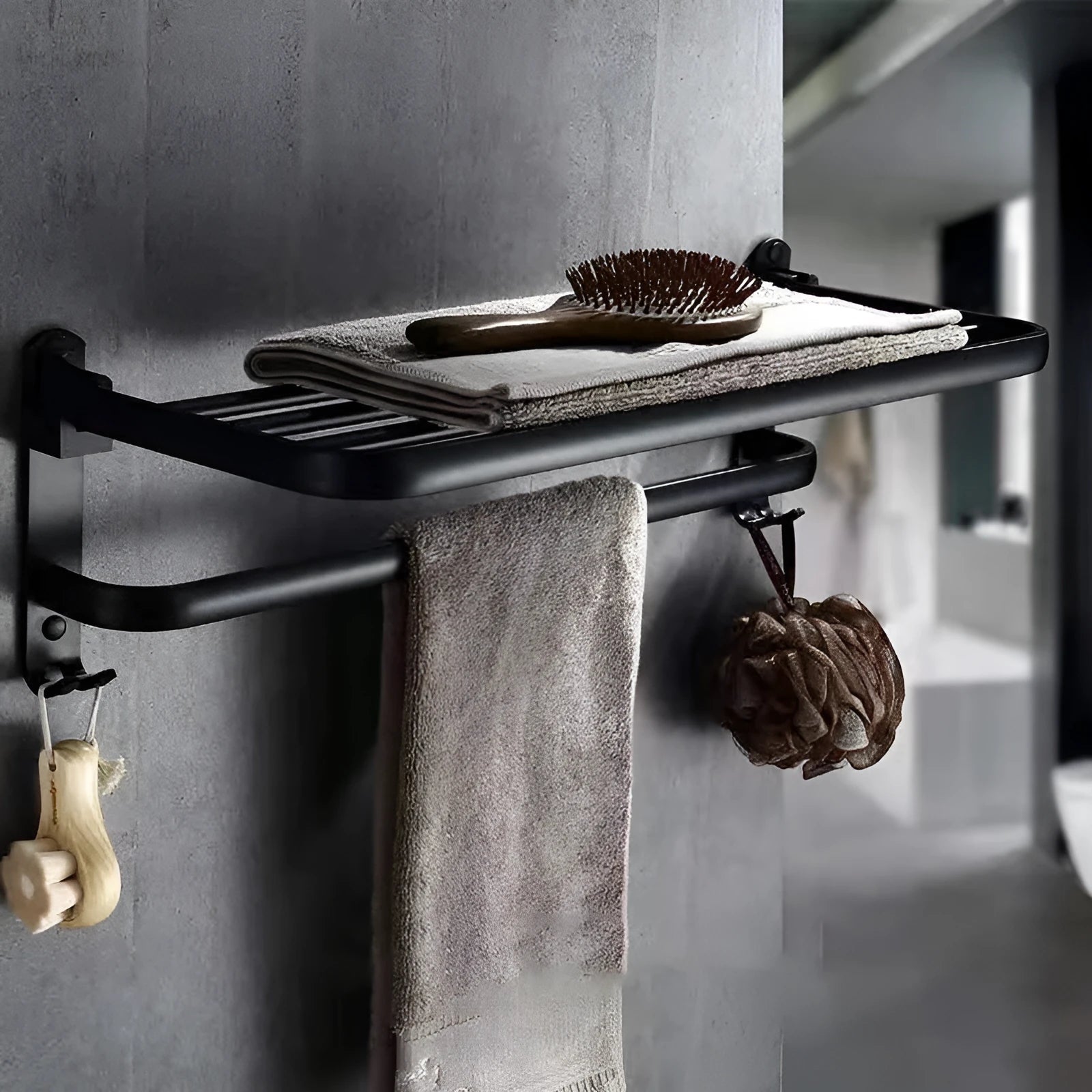 Silver aluminium two-tier folding towel rack with perforated shelves mounted on a bathroom wall.