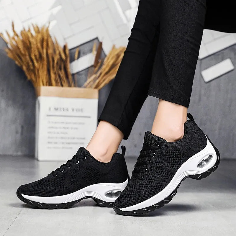 Women's air cushion heightening sports shoes in black with flying weave upper and lace closure