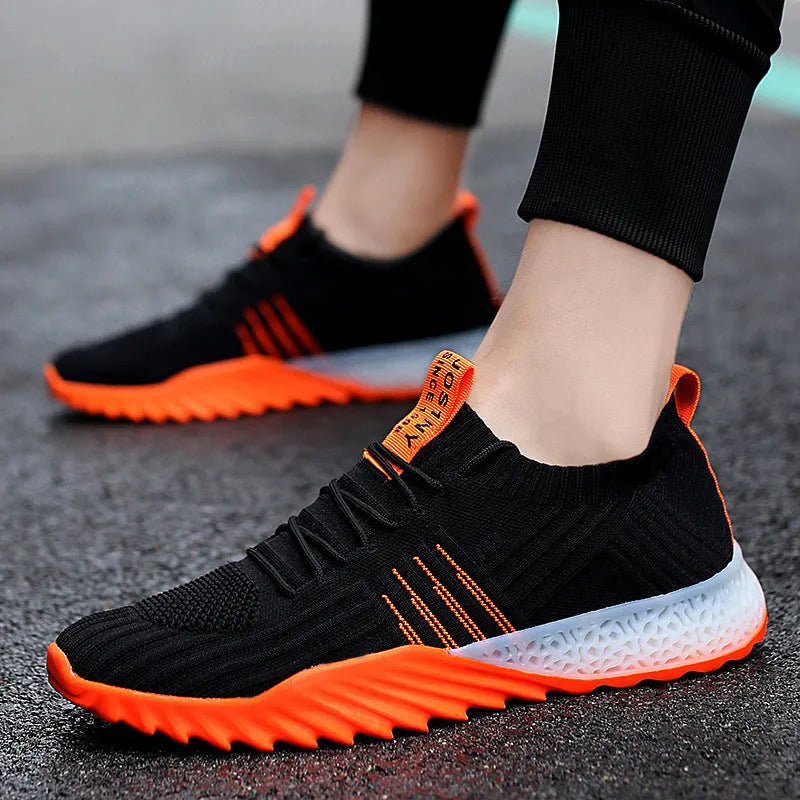 Flying woven mesh breathable sneakers in white orange with rubber sole and car suture detail