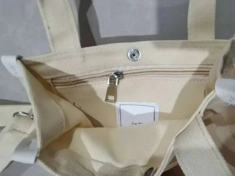 Canvas small square tote bag with magnetic buckle and zipper pocket in black, khaki, red, or white.