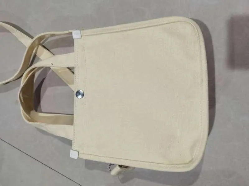 Canvas small square tote bag with magnetic buckle and zipper pocket in black, khaki, red, or white.