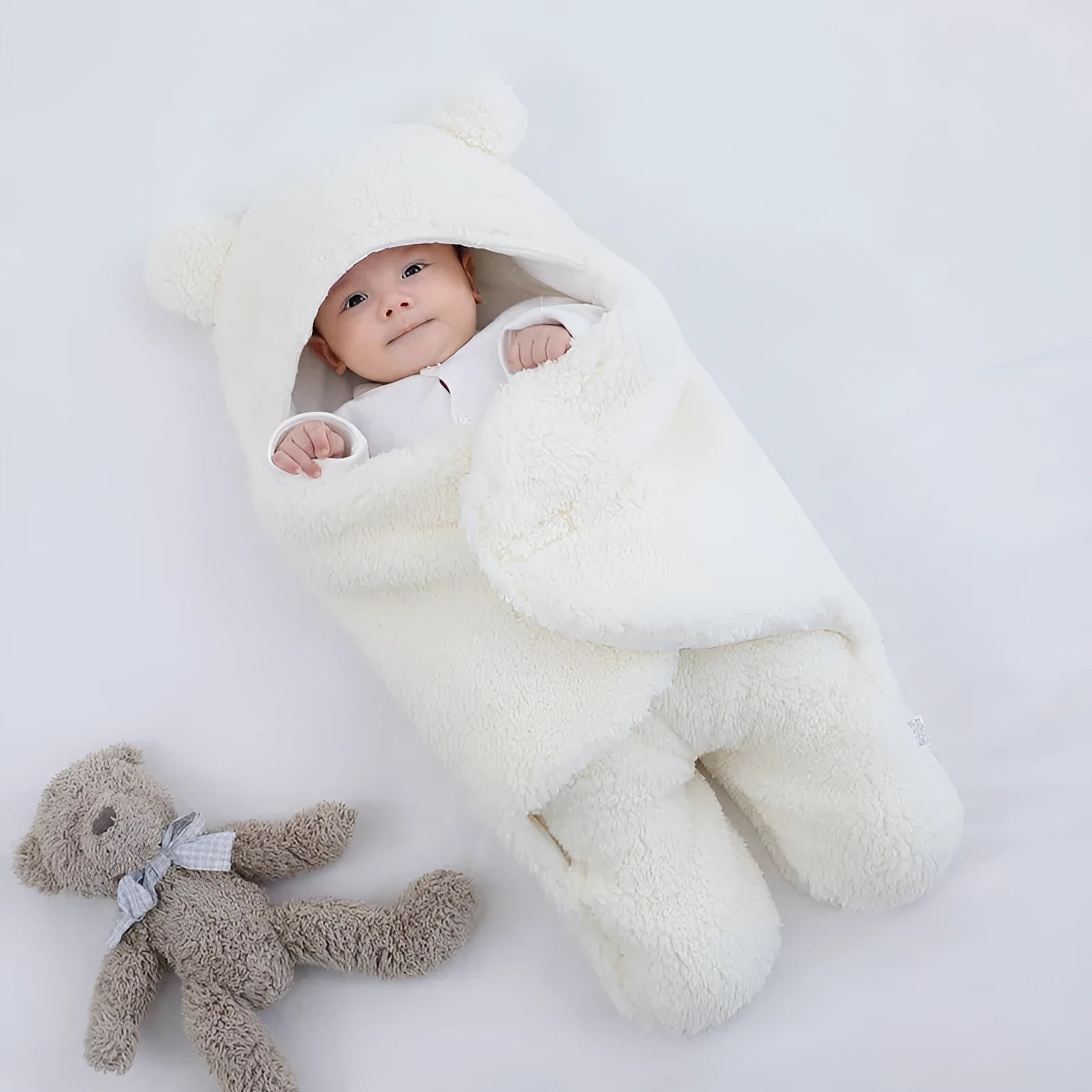 Cotton blend baby quilted sleeping bag wrapper in light blue, shown with size labels for 3M, 6M, and 9M.