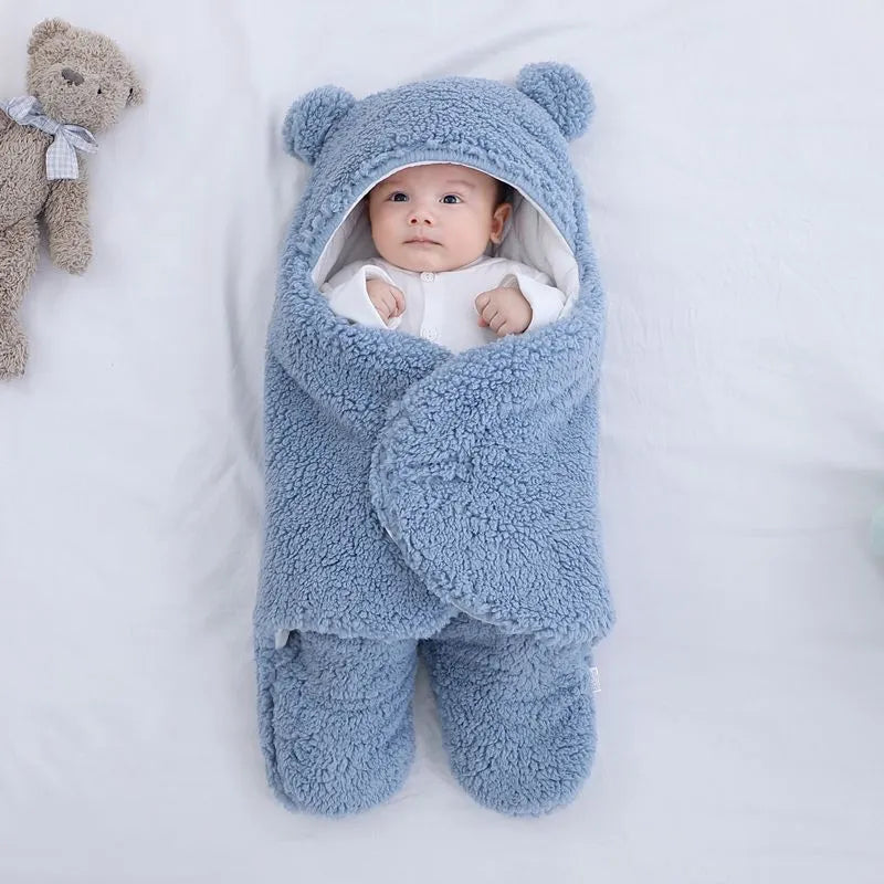 Cotton blend baby quilted sleeping bag wrapper in light blue, shown with size labels for 3M, 6M, and 9M.