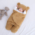 Cotton blend baby quilted sleeping bag wrapper in light blue, shown with size labels for 3M, 6M, and 9M.
