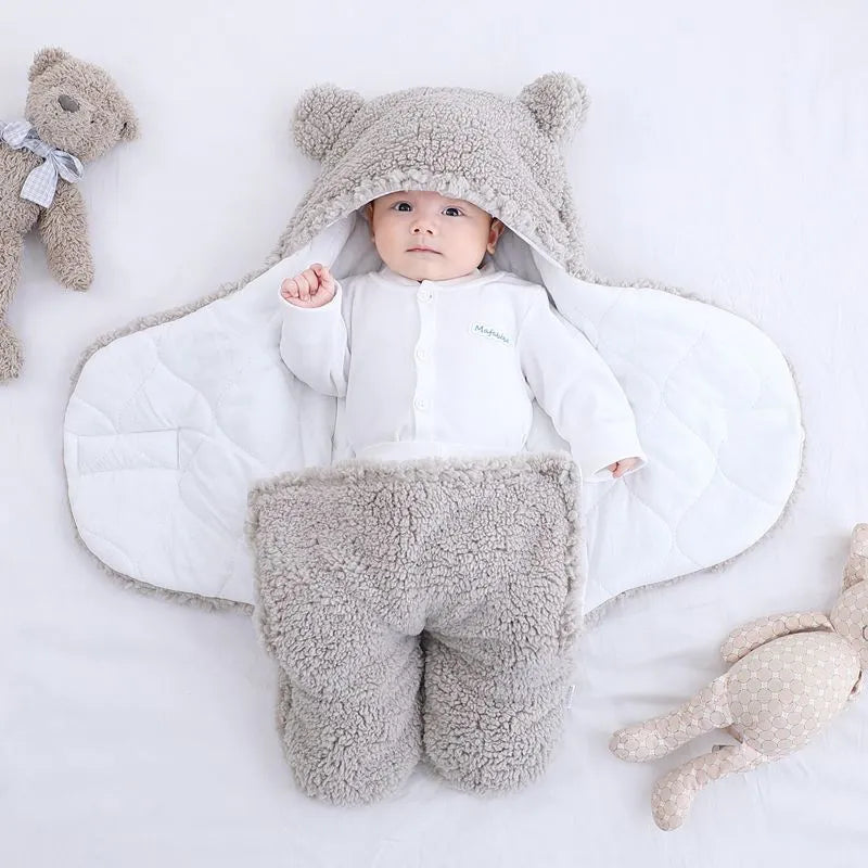Cotton blend baby quilted sleeping bag wrapper in light blue, shown with size labels for 3M, 6M, and 9M.
