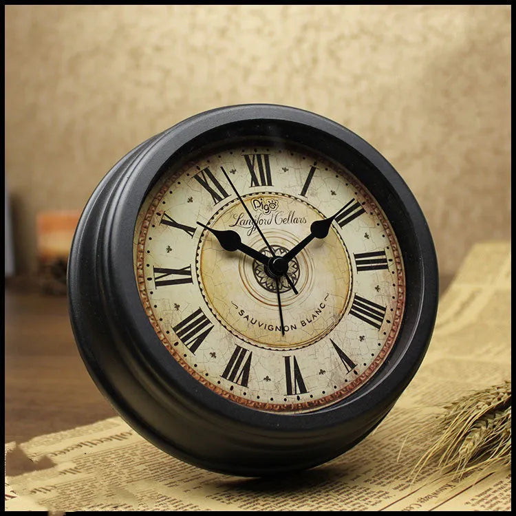 Round European retro style desk clock with silent alarm on a wooden desk.