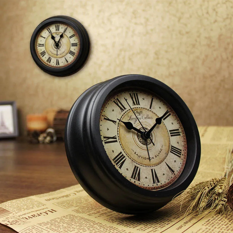 Round European retro style desk clock with silent alarm on a wooden desk.