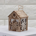 Set of three handmade wooden Christmas decorations: a log bell and two rustic houses with old man and snowman.