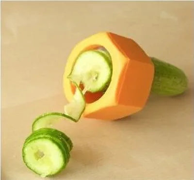 Yellow and green plastic spiral vegetable cutter for kitchen use on a white background.