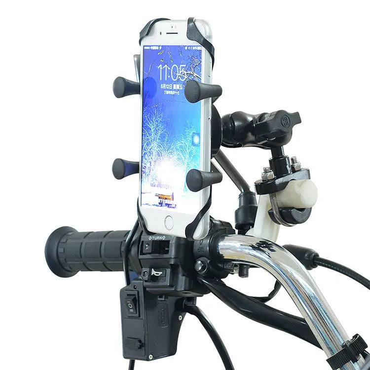 Black aluminium alloy motorcycle phone mount bracket attached to a bicycle handlebar, holding a mobile phone.