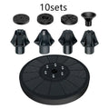 Black solar fountain pump with four spray nozzles on a green grass background next to a birdbath.