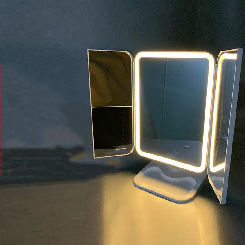 Trifold makeup mirror with 68 LED lights, 10X detachable magnifying mirror, and 180-degree rotation on a table