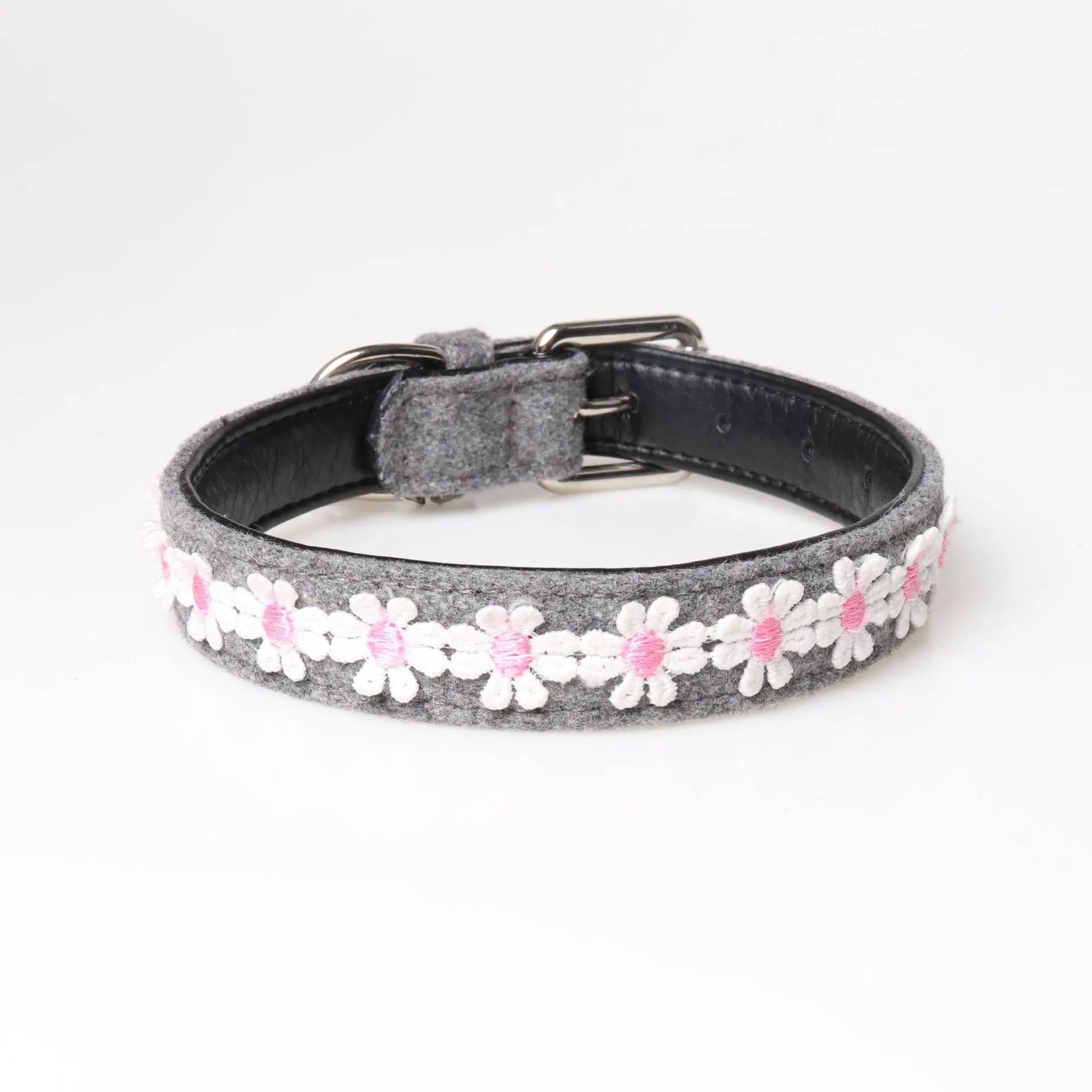 Embroidered PU dog collar with metal buckle on a neutral background, available in four colours and two adjustable sizes