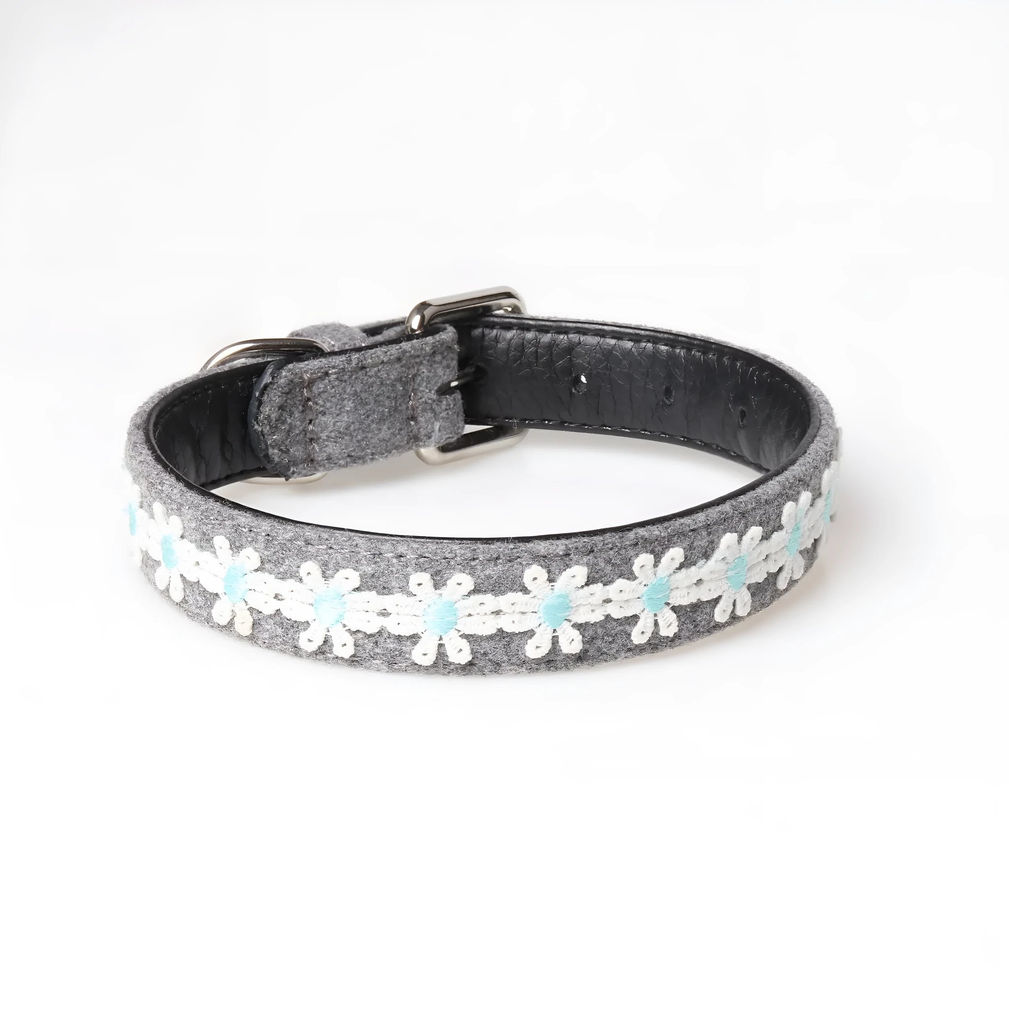 Embroidered PU dog collar with metal buckle on a neutral background, available in four colours and two adjustable sizes