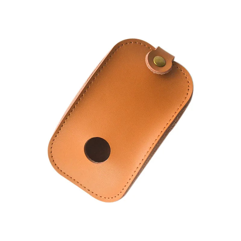 Brown leather storage bag for Apple Magic Mouse 2nd Generation, with a Magic Mouse partially visible inside, on a wooden desk.