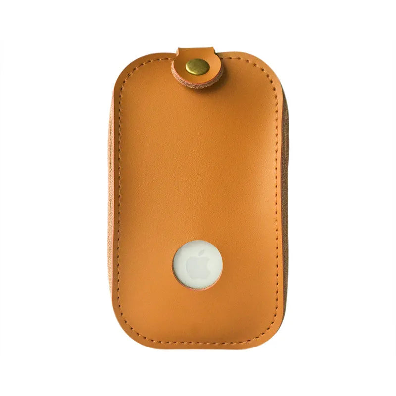 Brown leather storage bag for Apple Magic Mouse 2nd Generation, with a Magic Mouse partially visible inside, on a wooden desk.