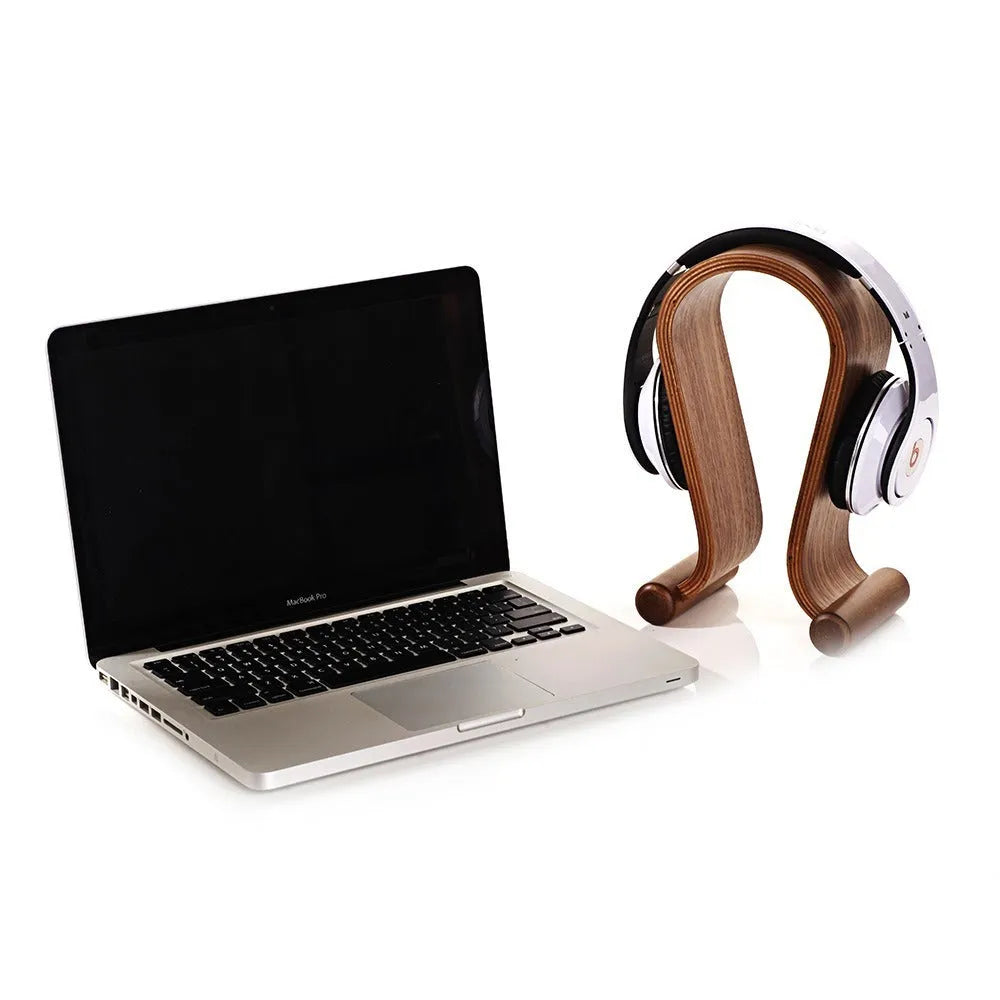 Solid wood earphone display rack with natural wood grain finish on desk