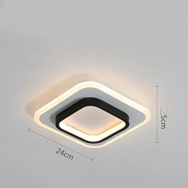 Aluminium and acrylic LED corridor light for aisles and balconies, black and white finish, circular warm light variant
