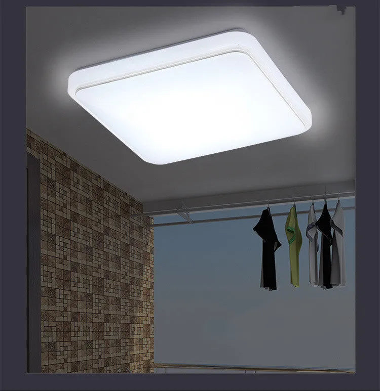 Square LED ceiling lamp with gold line trim on ceiling in a living room setting