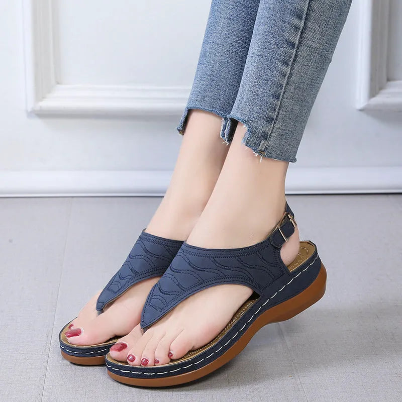 Women's black casual wedge heel sandals with an adjustable back strap buckle.