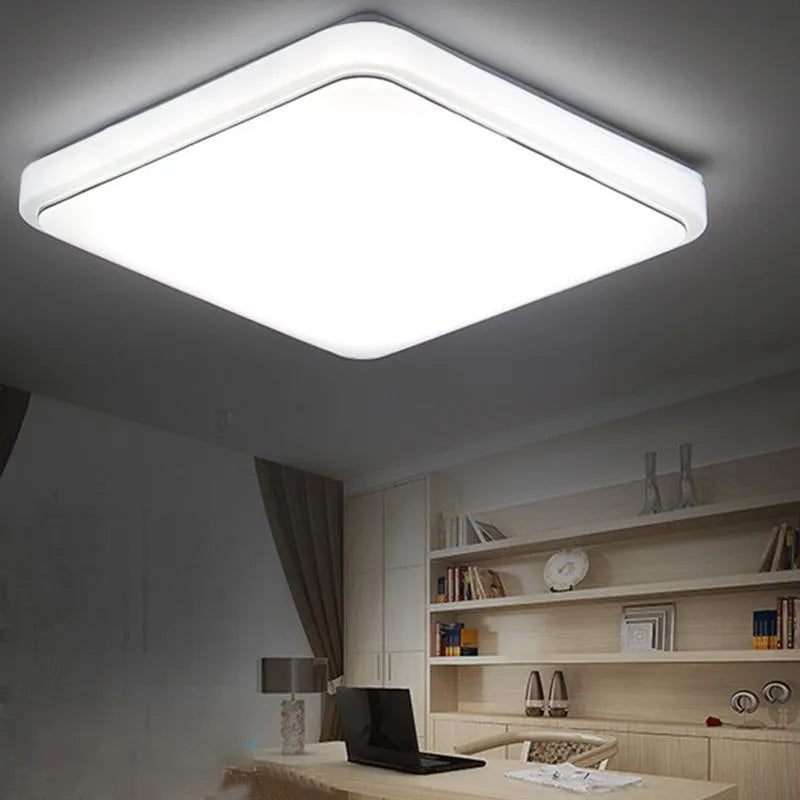 Square LED ceiling lamp with gold line trim on ceiling in a living room setting