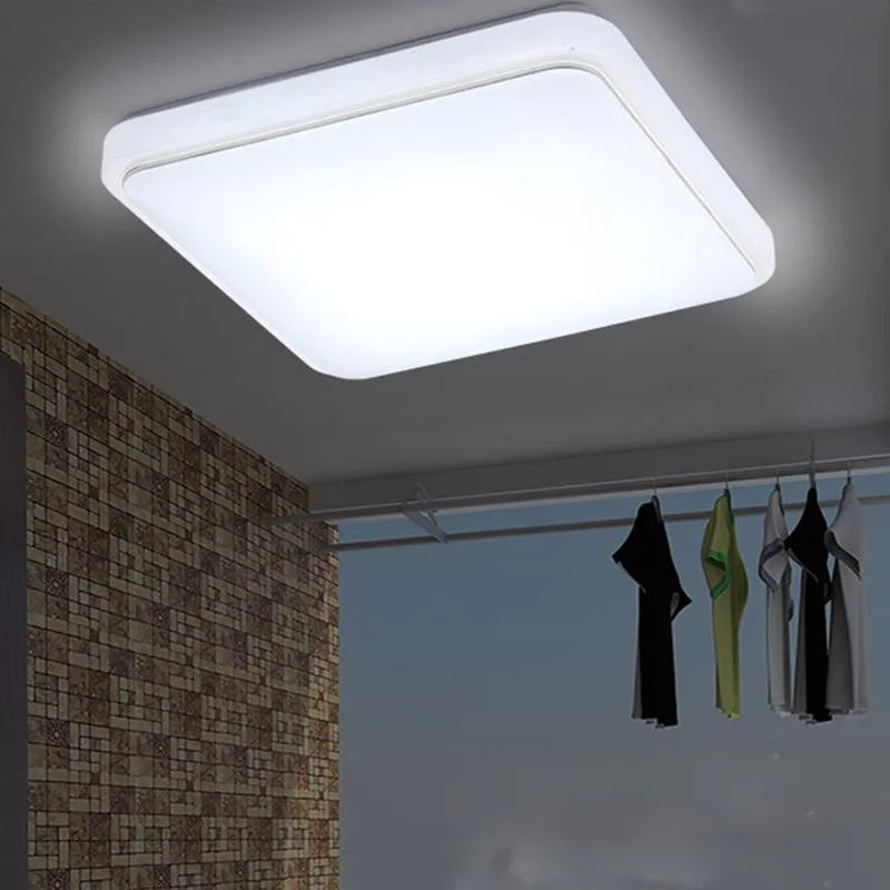 Square LED ceiling lamp with gold line trim on ceiling in a living room setting