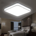 Square LED ceiling lamp with gold line trim on ceiling in a living room setting