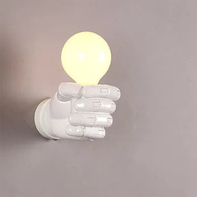 Creative resin fist wall lamp in black, white, or wood grain for left or right hand mounting.