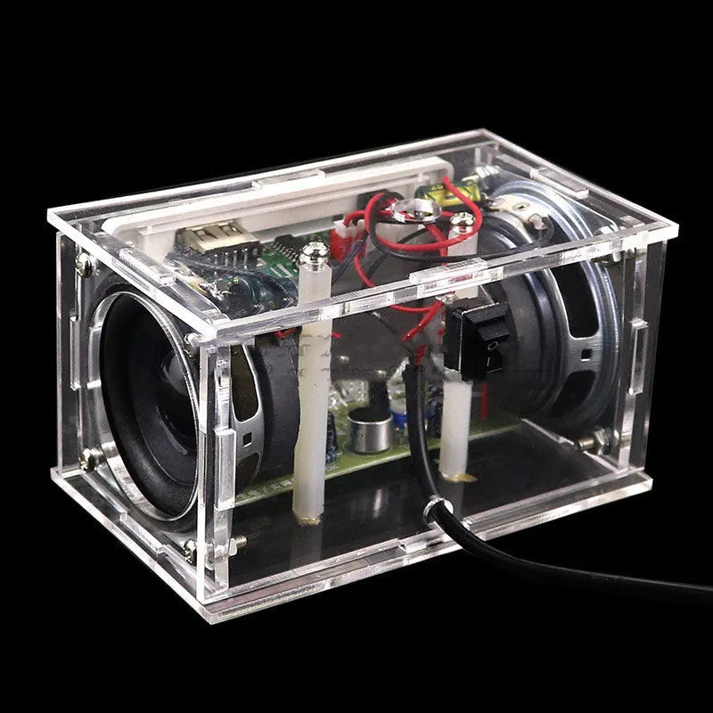 Bluetooth speaker DIY kit components including circuit board, loose electronics, speaker, and clear plastic shell.