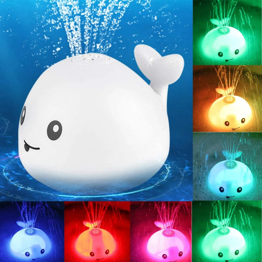 Whale-shaped baby bath toy with automatic water spray, flashing lights, and music on a base.