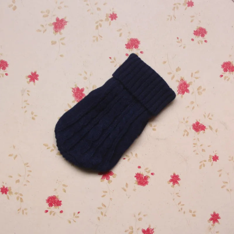 Knitted wool dog sweater with fabric buttons on a white background, shown in blue