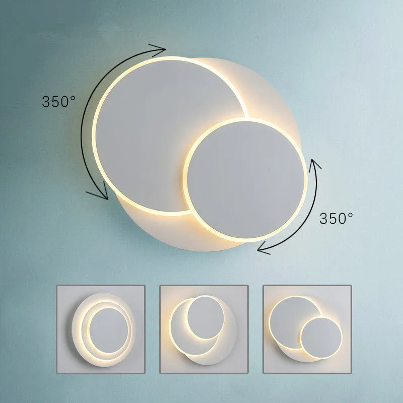 Modern round wall lamp with white acrylic shade and decorative circles on a wall.