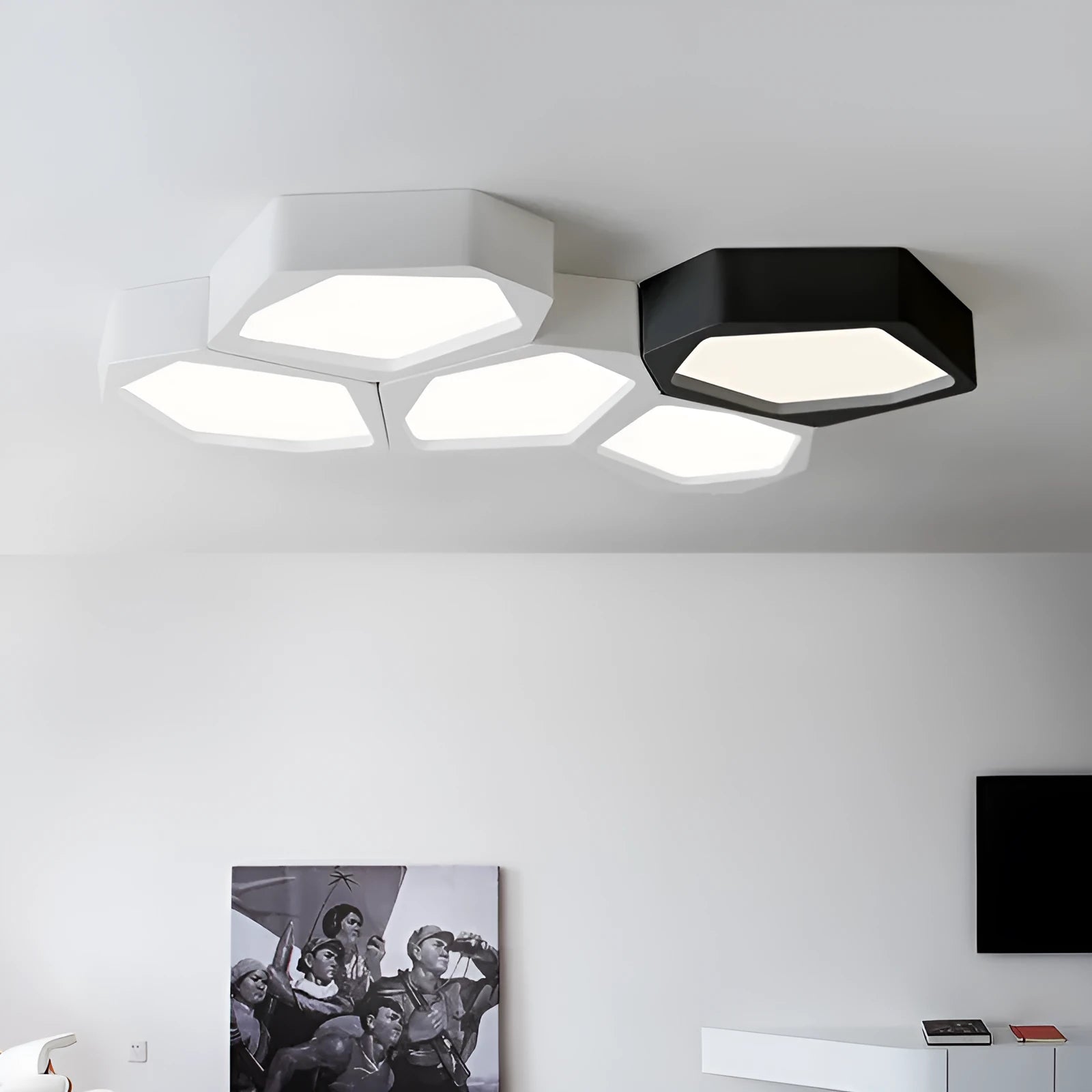Geometric shaped iron LED light fitting in black or white with remote control for dimming and colour temperature.