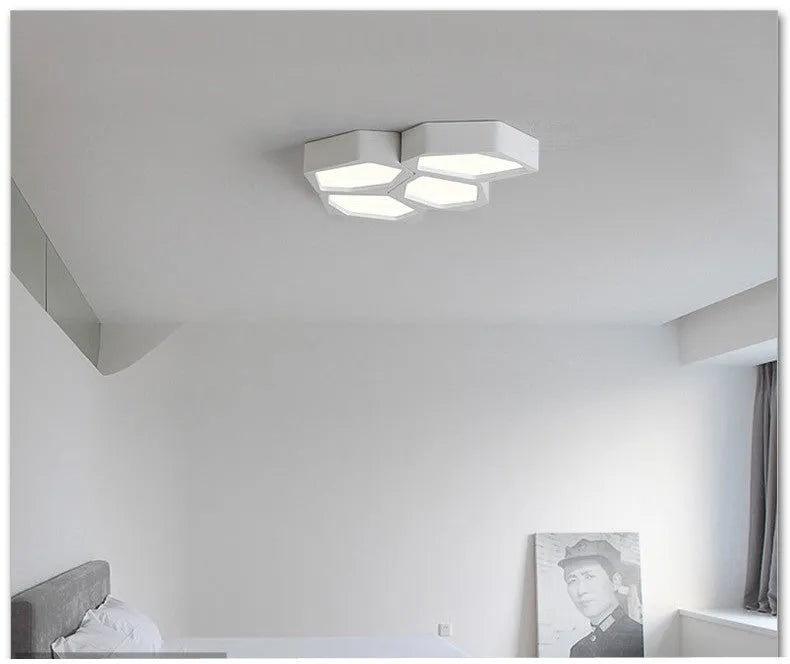 Geometric shaped iron LED light fitting in black or white with remote control for dimming and colour temperature.