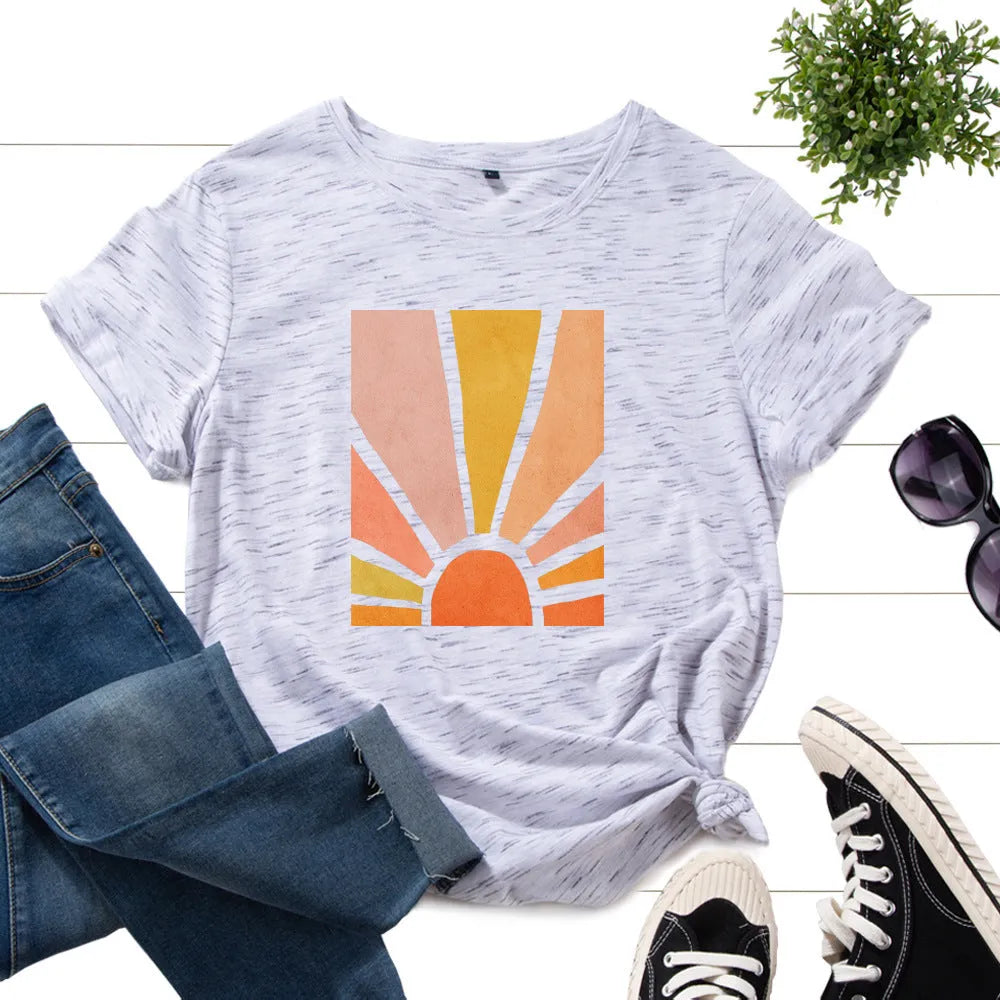 Women's cotton graphic tee with short sleeves and crew neck featuring a printed sun scenery and flower design